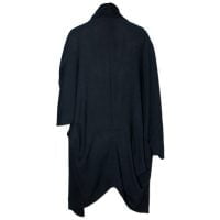 A Japanese inspired throw over cardigan with wide 3/4 sleeves made from a light knit in black. Back View.