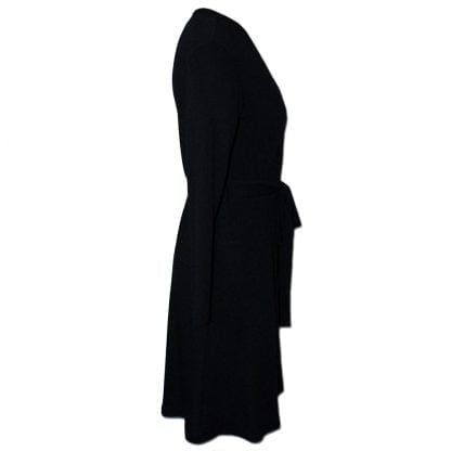 Nucleus Knit Coat in Black is a coat made from knit fabric that you can wrap around you using a belt tie. It reaches below the knee and has long sleeves. Side View