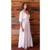 Lady wearing an off white long length cream dress to a wedding