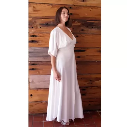 Lady wearing an off white long length cream dress to a wedding